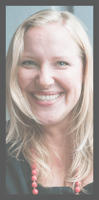 Sophie Toolanen smiling with red necklace and black sweater
